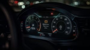 A modern digital car dashboard instrument cluster at night featuring erratic, pulsating flickering lights, visually signaling an underlying electrical charging system fault.