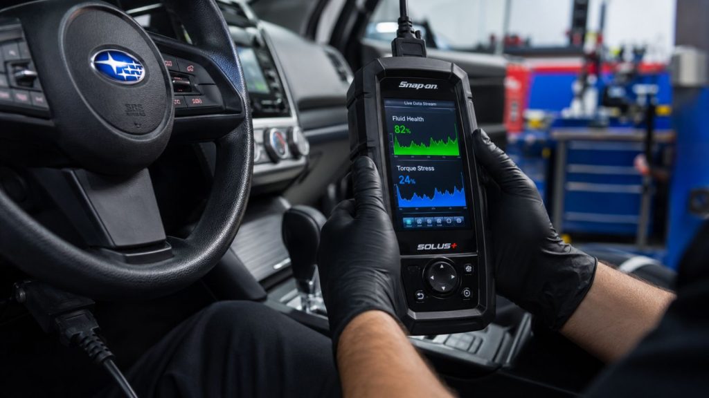 A technician at Ruben's Auto Repair uses a professional diagnostic scanner to monitor Subaru CVT fluid and torque trends, identifying issues before they require major transmission repairs.