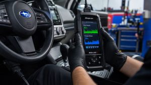 A technician at Ruben's Auto Repair uses a professional diagnostic scanner to monitor Subaru CVT fluid and torque trends, identifying issues before they require major transmission repairs.